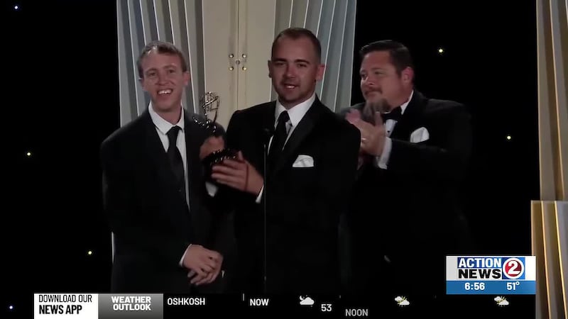 Anchor Emerson Lehmann (center) leads a WBAY delegation accepting the Regional Emmy for Action...